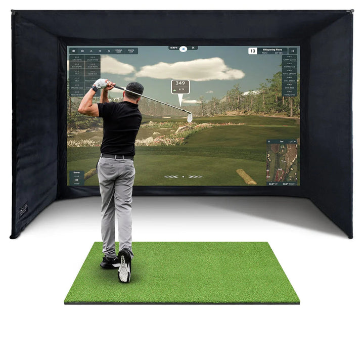 Golfer practising in a black DIY enclosure with projected golf course