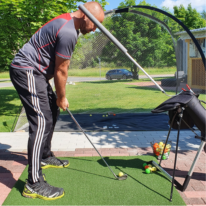 GOSWO HMC Flex Sticks head movement practice beside a golf net
