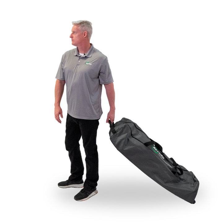 Man walking with the Net Return Pro on the Go duffle bag by the side carry handle.