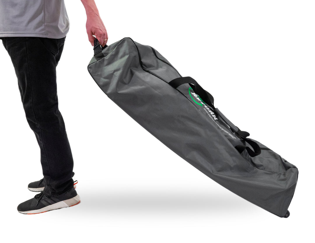 Person pulling the Pro on the Go duffle bag in motion, close-up on handle and angle.