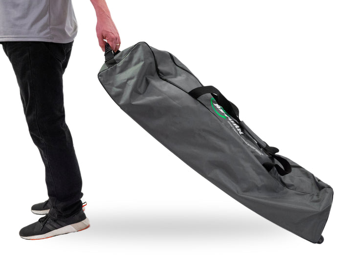 Person pulling the Pro on the Go duffle bag in motion, close-up on handle and angle.
