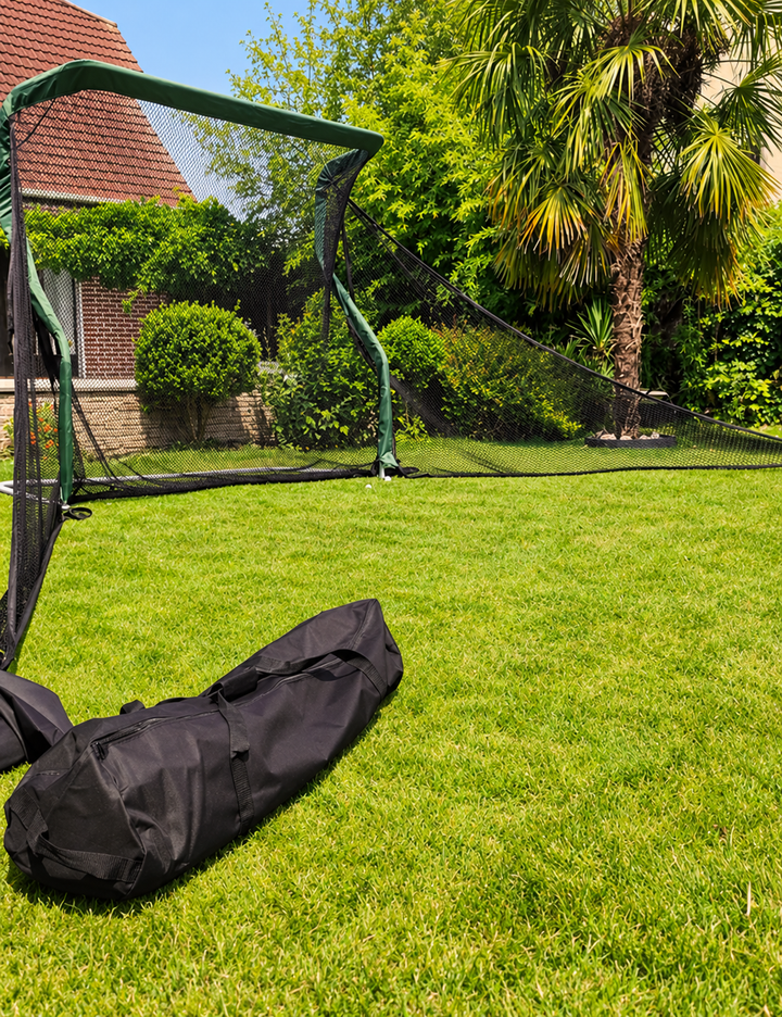 Practice Net Pro in a garden with side protection nets and a black carry bag in the foreground